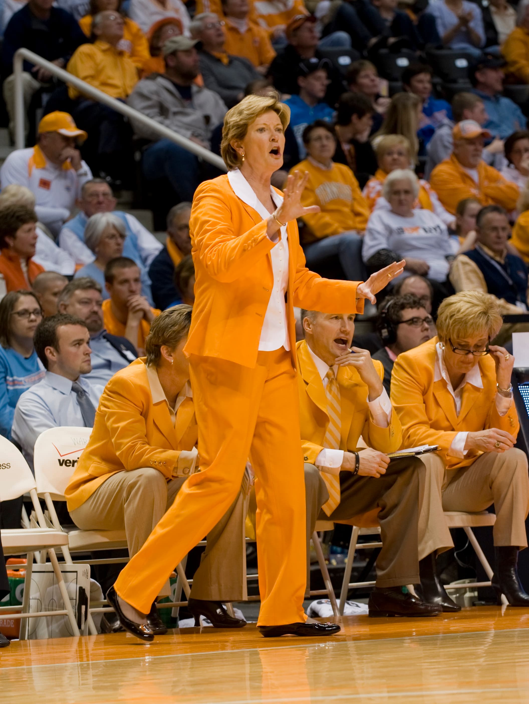 Coach Pat Summitt coaching from the sideline in an orange suit
